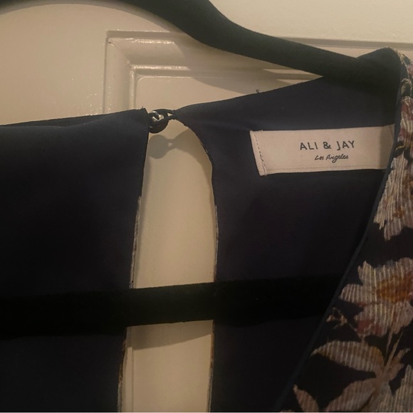 Floral jumpsuit with sheer long sleeves and side tie. Never been worn. - Picture 5 of 6